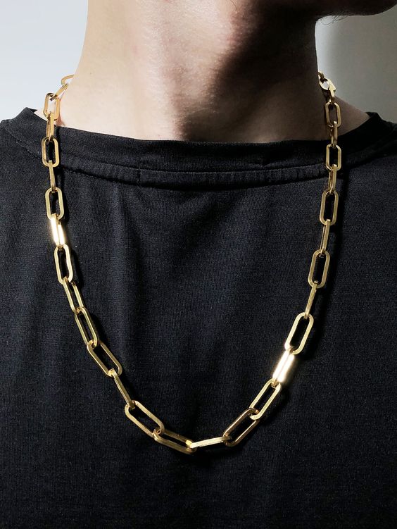 Thin gold paperclip chain necklace layered style men's minimalist jewelry close up