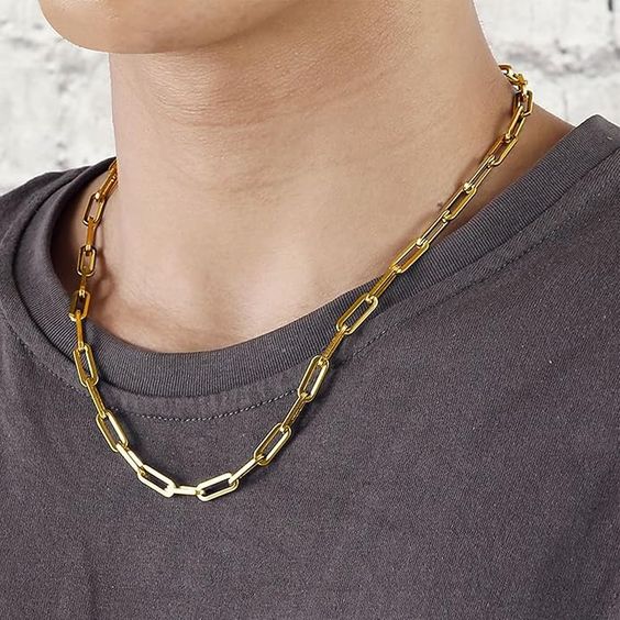 Thin gold paperclip chain necklace layered style men's minimalist jewelry close up
