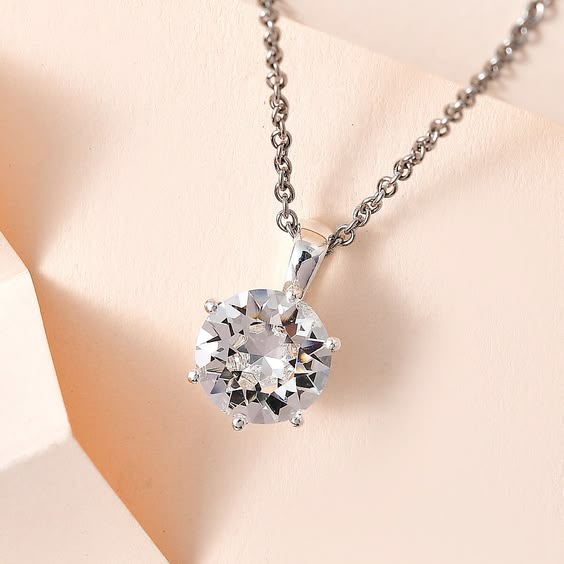 Woman wearing minimal solitaire CZ pendant necklace on silver chain