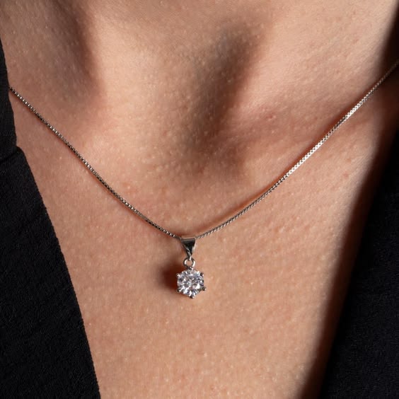 Woman wearing minimal solitaire CZ pendant necklace on silver chain