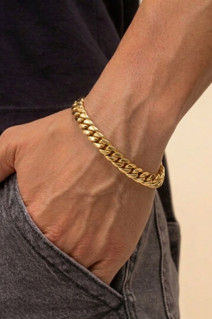 Men's chunky gold cuban link bracelet on wrist