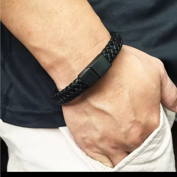 Black braided leather bracelet for men with magnetic steel clasp worn on wrist - Texora