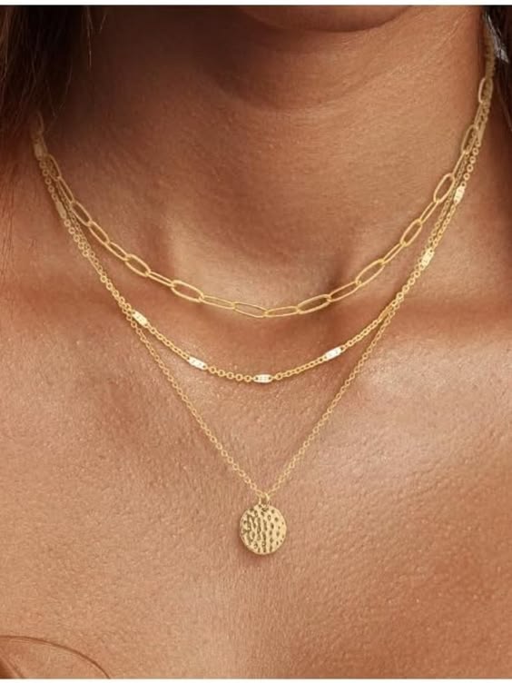 Woman wearing double layer gold paperclip and rope chain necklace