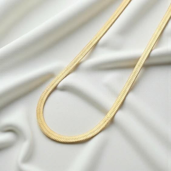 Men's black herringbone chain necklace flat lay on white background stainless steel