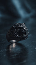 Men's matte black stainless steel signet ring with 3D embossed tiger head design on white background